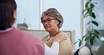 Senior woman, nurse and console in home on sofa, talk or discussion with services for wellness in retirement. Elderly person, caregiver and consulting with support, report and explain in living room