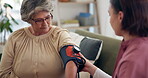 Healthcare, senior patient and nurse for blood pressure, diabetes assessment and medical check up in home. Caregiver, test and pump on elderly woman for diagnosis, hypertension level and consultation