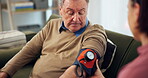 Woman, nurse and mature man with blood pressure test for healthcare, checkup and exam in nursing home. Doctor, cardiology and people for medical support, cholesterol and senior patient with caregiver