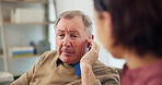 Nurse, mature man and hearing aid on ear for medical support, wellness and innovation. Person with a disability, healthcare worker and deaf patient with audiology implant, service and sound waves