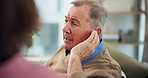 Nurse, senior man and hearing aid on ear for medical support, wellness and innovation. Person with a disability, healthcare worker and deaf patient with audiology implant, service and sound waves