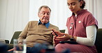 Diabetes pen, nurse and senior man on sofa, injection and consultation in living room. Mature patient, home and medical with professional, healthcare and needle prick with insulin and wellness