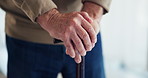 Hands, walking stick and retirement in house with balance, steps or recovery from injury in morning. Elderly person with disability, wooden cane or rehabilitation process for mobility at nursing home