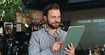 Business, tablet and man in restaurant, smile and internet with connection, online order and friendly service. Person, manager or employee in cafe, tech or app with checklist for stock or hospitality