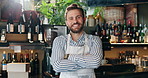 Waiter, face and man with arms crossed in restaurant for customer service, hospitality industry and confidence. Barista, person and happy entrepreneur in bistro for small business, pride and cashier