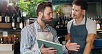 Meeting, tablet and men in coffee shop talking for planning, discussion and training in cafe. Small business, restaurant and waiter with manager on digital tech for inventory, menu and online orders