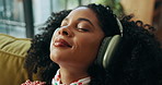 Headphones, music and happy woman with peace in home, streaming sound or subscription for calm. Living room, audio technology and African person listening to favorite song, radio and podcast to relax