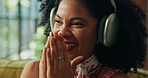 Headphones, podcast and happy woman laugh in home, streaming sound or comedy subscription. Living room, audio technology and African person listening to funny radio, audiobook or relax with happiness