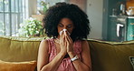 Woman, sneeze and tissue on sofa in house, sick and sinusitis with flu, allergy and rest in living room. African person, cleaning nose and nasal inflammation with cold, mucus or hygiene at apartment