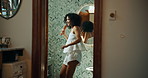 Woman, brush and singing with dancing by bathroom mirror, happy and playful with voice, sound and morning in home. Person, hair care and smile with karaoke, song and funny performance at apartment