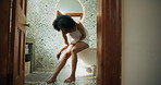 Washing, shaving legs and African woman in bathroom for cleaning, wellness and grooming in home. Morning, beauty and person with razor, foam and cosmetics for epilation, hair removal and smooth skin