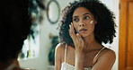 Bathroom, mirror and woman with cream for skincare, wellness and apply for morning routine at home. Reflection, benefits and female person in house with cosmetics treatment, hygiene and face lotion
