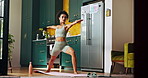 Fitness, girl and stretching in home for yoga, muscle tension relief and healthy body. Woman, warrior pose and posture in kitchen for breathing exercise, wellness and holistic activity for self care