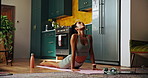 Home, laptop and woman with cobra stretching for flexibility, virtual tutorial and balance for wellness. House, female person and fitness with breathing for wellbeing, yoga lesson and holistic health