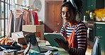 Woman, fashion designer and tablet in workshop with laptop, inspection or inventory check at small business. Person, digital touchscreen and app for review, shipping and boxes for order at studio