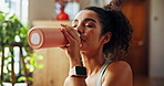 Home, woman and fitness with drinking water for nutrition, hydration or wellness for healthy body. House, female person and break with thirst for h2o liquid, detox or self care after exercise session