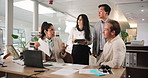 Teamwork, laptop and business people in office, meeting and conversation with feedback for article. Group, magazine editor or journalist in workplace, cooperation or pc with review, ideas or planning