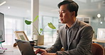 Corporate, online and Asian man with laptop, office and sales manager with notes for project or review. Reading, employee and person with tech for financial report, typing and planning in business