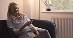 Relax, happy and watching tv with woman on sofa streaming movie, video and television. Smile, peace and news with female in living room at home for subscription, service and lounge lifestyle 