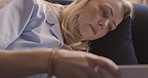 Night, relax and woman reading a book laying on sofa at home, enjoy quiet evening. Calm, peace and close up of middle aged female in living room relaxing on couch to read, unwind and rest on weekend
