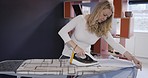 Woman, home and iron with shirt, clothes and board for domestic, work and job with focus, clean or garment. Fashion, fabric and laundry to press wrinkles from material, cloth or cotton in house