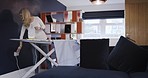 Woman, nurse iron clothes or uniform, dressing for work in morning in her home while getting ready. Mature lady cleaning, doing chores with ironing board and shirt or laundry for routine service