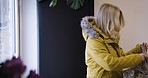 Woman, jacket and leave house with bag for shopping trip in the city. Mature woman getting ready and wearing winter coat for journey in cold town for consumer shop to buy or purchase items.