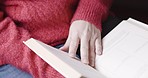 Relax, book and reading with a woman in glasses sitting in her home while enjoying a novel or literature. Books, knowledge and read with a mature female reader relaxing in the living room of a house