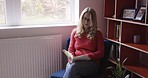 Woman, book and reading at home for rest, relaxation and knowledge. Mature woman resting at home with novel for stress relief and peace in her house. Study, education and woman learning with book