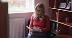 Woman, reading book and content on chair, relax and in home with glasses, in living room and calm thinking. Senior female, lady and flip pages in journal to be peaceful, learning and study in lounge.