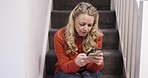 Phone, stairs and woman in home on social media, web browsing or internet surfing. Tech, smartphone and female from Australia on 5g mobile reading text message, typing or on online app in house alone