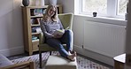 Woman reading book, relax and hobby, free time at home and sitting in chair, enjoy and leisure in bedroom. Student, read and text, research for project or self care lifestyle with relaxing and calm.