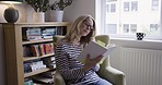 Senior woman, with glasses and book to reading, with calm and relax in study, living room or sit on chair. Elderly female, mature lady or eye care check journal, novel or notebook to focus or content