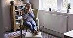 Health, armchair and woman blowing nose with tissue, relax and feeling sick in living room at home. Healthcare, rest and girl in isolation or quarantine in apartment with Covid, sinus allergy or cold