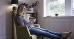 Communication, phone and lonely woman on sofa at home, sitting by window. Depression, sadness and middle aged female alone in living room texting, typing and having online conversation on smartphone