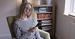 Woman, earphones and smartphone to listen in home to podcast, ebook and relax in living room, for streaming music and content. Mature female, headphones and cellphone listening to radio being happy.