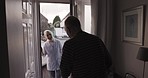 Door, visit and opening of senior man, greeting and welcome nurse to care home. Old guy answering front door of retirement house for doctor woman to say hello