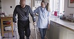 Home healthcare nurse, senior man and woman support elderly retired person in kitchen. Medical caretaker, aid physical therapy patient and health conversation walking in nursing retirement house