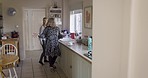 Family, home and tea or coffee with mother and daughter or friends cleaning, talking and bonding in the kitchen together. Woman and senior lady doing morning routine at breakfast or clean at visit