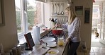 Mature woman in kitchen, cooking food in London home and vegan menu for breakfast to learn meal recipe. Healthy vegetable lunch, chef at stove with spoon or diet nutrition for dinner