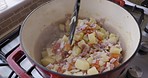 Hands, food and cooking with a pot on a gas stove in the kitchen to prepare a meal for healthy eating from above. Vegetables, nutrition and diet with a person preparing lunch or dinner in a house