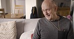 Talking, laughing and recovery with a senior man joking in the living room of his retirement home. Conversation, funny and rehabilitation with a mature male patient in a nursing facility for care