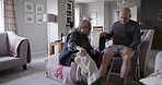 Physio, rehabilitation and recovery with a senior couple sitting together in their retirement home. Pain, injury and arthritis with an elderly male and female pensioner healing in their house