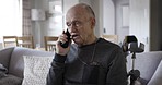 Call, physiotherapy and rehabilitation with a senior man talking on his phone while in his retirement home. Healthcare, conversation and mobile with an elderly male in a house for recovery