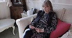 Senior couple, tablet and man sleeping on couch while in rehabilitation for pain and resting on living room couch at, home. Elderly woman on social media or reading an ebook while caring for husband