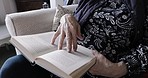 Retirement, woman and reading a book while relax at home feeling calm and peaceful for knowlege and learning. Education, novel and story with senior retired female read on living room couch 