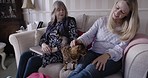 Friends, family or women in a couch with a cat for love, care and trust at home together for quality time and bonding. Mother and adult child on sofa with animal pet during visit at nursing home