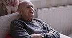 Talking, relax and rehabilitation with a senior man sitting on a sofa in the living room of his retirement home. Health, medical and conversation with a mature male patient in his house for recovery