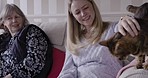 Family, love and cat with a senior woman and adult daughter stroking a pet on a sofa in a house living room together. Animal, visit and relationship with a female and mother in a retirement home