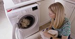 Household, laundry and woman with clothes in washing machine for cleaning, washing and fresh clothing. Hygiene, housework and girl packing fabric from basket in washer in kitchen for housekeeping